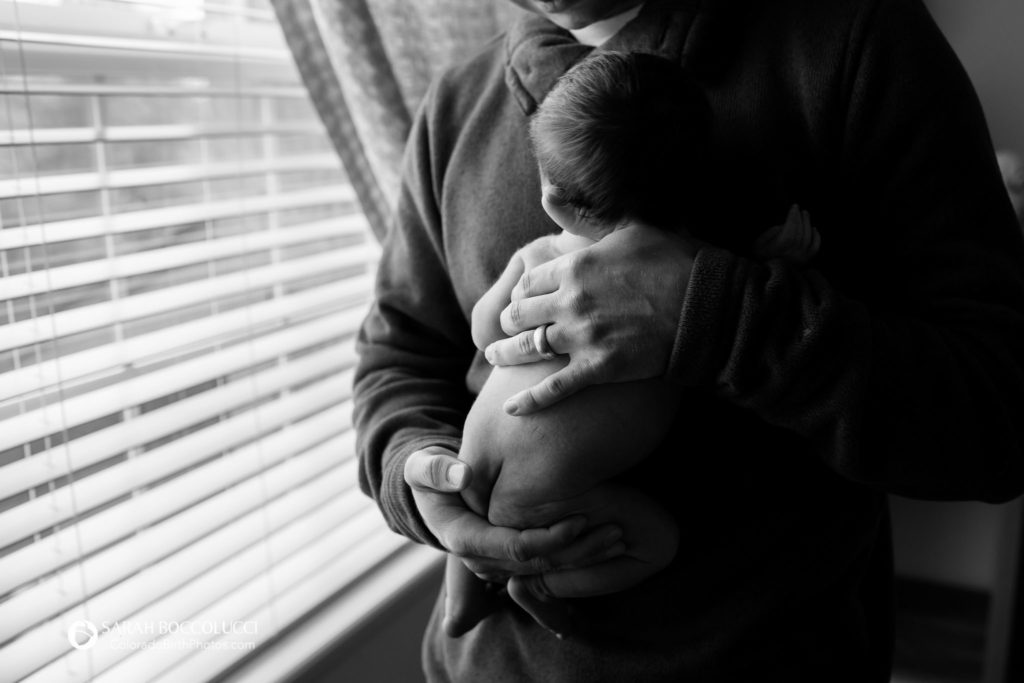 In Home Newborn Photography baby in dad's arms