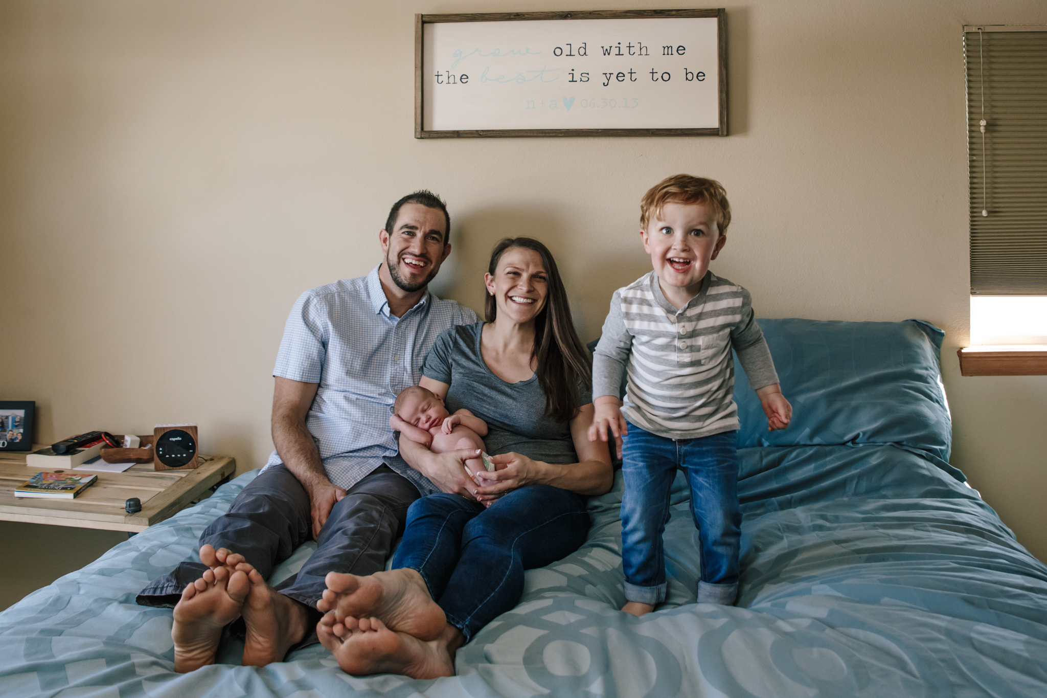 Westminster Colorado Newborn photographer jumping on bed