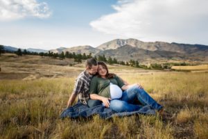 Johnston, Colorado maternity photographer, couple sitting in field