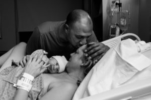 Lafayette Colorado Birth Photographer dad kissing mom